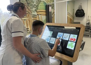 Patient uses accessible interactive tablet in the Neurosciences Department