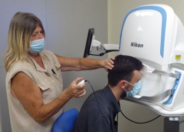 Patient having eyes scanned using the Optos Camera at the NNUH Eye Clinic