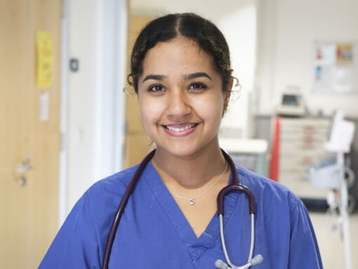 Doctor in scrubs with stethoscope around her neck