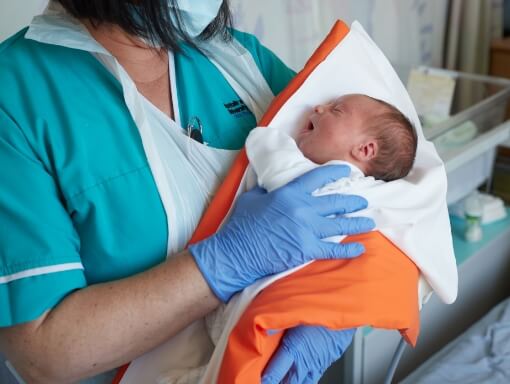 Midwife holding a newborn baby