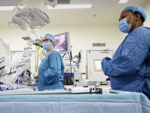 Two surgeons with a surgical robot